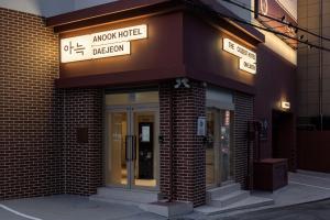 a building with a sign that reads arrow hotel defense at Anook Hotel Jungangro Station in Daejeon