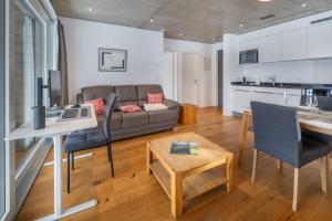 a living room with a couch and a table at Schwarzhornblick in Grächen
