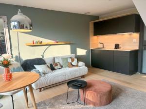 a living room with a couch and a table at La Rosière en Gaume in Musson