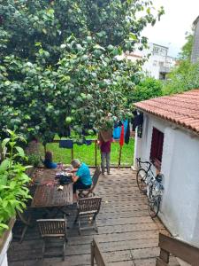 two people sitting at a picnic table in a garden at mundoalbergue in Santiago de Compostela +4 photos