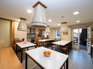 a dining room with tables and chairs with oranges on them at mundoalbergue in Santiago de Compostela