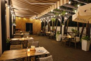 a restaurant with tables and chairs and lights at Hotel Ajax in Janki