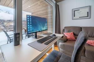 a desk with a computer monitor and a keyboard at Schwarzhornblick in Grächen +33 photos