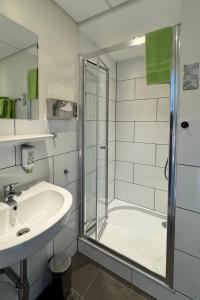 a bathroom with a shower and a sink at Boutique Hotel Restaurant Hollerather Hof in Hellenthal +93 photos