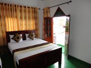 a bedroom with a bed and a window at Home Living Unit in Galle