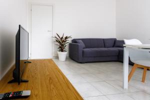 a living room with a couch and a tv at Alpoggiouno in Vercurago