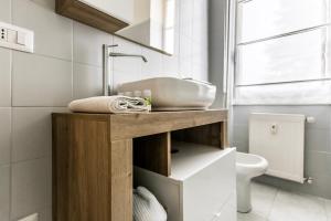 a bathroom with a counter with a sink and a toilet at Alpoggiouno in Vercurago +17 photos