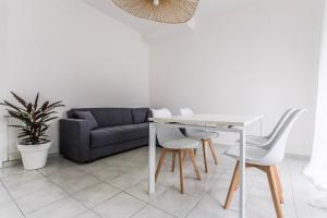 a living room with a table and a couch at Alpoggiouno in Vercurago