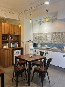 a kitchen with a wooden table and chairs at Hostel Espace in Chuncheon +21 photos