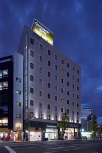 un edificio de hotel con un cartel encima en Centurion Hotel Grand Kobe Station, en Kobe