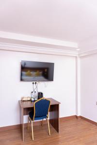 a desk with a chair in a room at Arise Sunshine Hotel in Narok