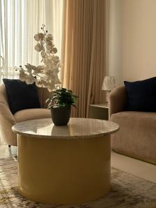 a living room with a table with a potted plant on it at Beach Front Escape in Wattala