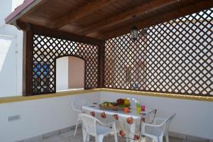 a dining room with a table and chairs and a mirror at Salento holiday house in Torchiarolo