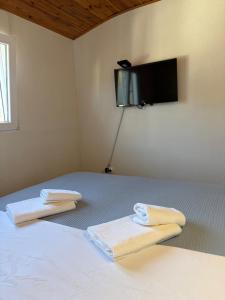 a bedroom with a bed with two towels on it at Verica in Dobrota