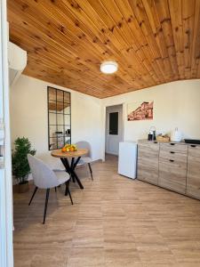 a kitchen and dining room with a table and chairs at Verica in Dobrota