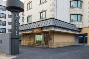 a building with a sign in front of it at Anook Ryokan Hotel Daejeon Daeheung in Daejeon