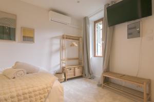 a bedroom with a bed and a mirror and a window at Le Nid Vert - air conditioning - ground floor in Bourg-en-Bresse