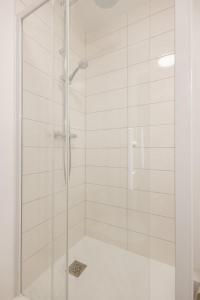 a shower with a glass door in a bathroom at Le Nid Vert - air conditioning - ground floor in Bourg-en-Bresse +17 photos