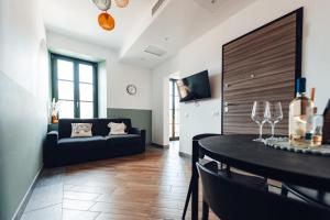 a living room with a couch and a table at Cà del Lasco - Free parking apartments 5 min from the station in Bellano