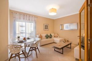 a living room with a table and a couch at Almancil Park Apartment in Almancil