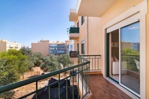 a balcony with a view of a city at Almancil Park Apartment in Almancil
