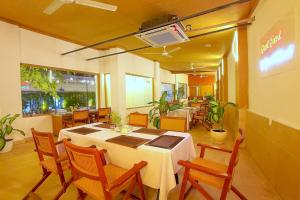 a dining room with a table and chairs and a restaurant at Lavender Private Villa Kuta Bali in Kuta