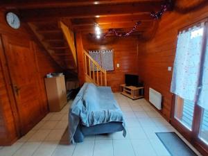 a bedroom with a bed in a wooden room at chalet 2007 in Le Boulay