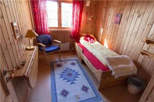 a bedroom with a bed and a desk and a chair at Gjestehus 1 Solåsen in Vestby