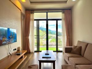 a living room with a couch and a table at PLAY at Nova Retreat Kea Farm in Cameron Highlands