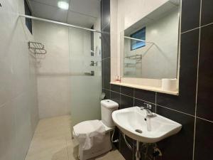 a bathroom with a sink and a toilet and a mirror at PLAY at Nova Retreat Kea Farm in Cameron Highlands +28 photos