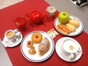 a table with two plates of food and cups of coffee at Villa La Stella in Florence