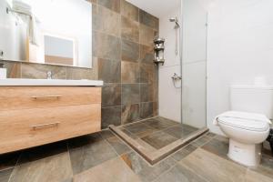 a bathroom with a toilet and a sink and a shower at Brassbell l Zamalek l Jeddah Tower in Cairo