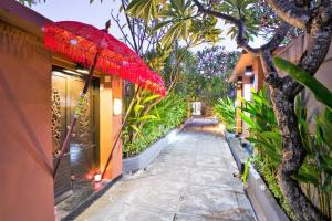 a red umbrella is hanging over a walkway at Lavender Private Villa Kuta Bali in Kuta