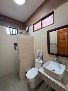 a bathroom with a toilet and a sink and a mirror at yamba pacifico in San Isidro +62 photos