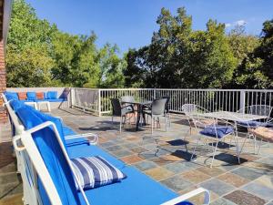 a patio with a table and chairs and a fence at Sunset on Silver Beautiful self catering Studio apt in Roodepoort