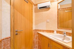 a bathroom with a sink and a mirror at Almancil Park Apartment in Almancil +5 photos