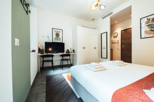 a bedroom with a bed and a desk in a room at Cà del Lasco - Free parking apartments 5 min from the station in Bellano