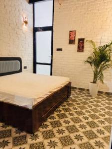 a room with a bed and a potted plant at Asmi by Beal's Farm in Jaipur