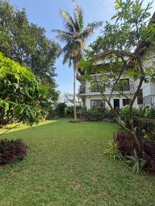a house with a palm tree in front of a yard at The fields Malabe in Malabe