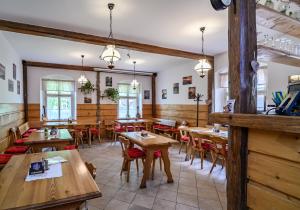 a dining room with wooden tables and chairs at Penzion u Hradilů in Vrbno pod Pradědem
