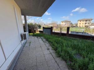 a porch of a house with a fence and grass at Ami Affittacamere 2 in Castel San Giovanni