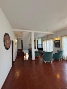 a living room with blue chairs and a tile floor at The fields Malabe in Malabe