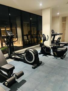 a gym with treadmills and exercise equipment in a building at Weekend villa in Rajkot
