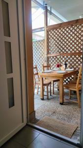 a dining room with a table and chairs and a window at Camping Continental in Mandello del Lario