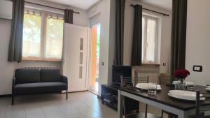a living room with a table and a chair at Camping Continental in Mandello del Lario
