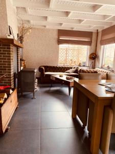 a living room with a couch and a table at vakantiewoning Charme Bohan Sur Semois in Vresse-sur-Semois