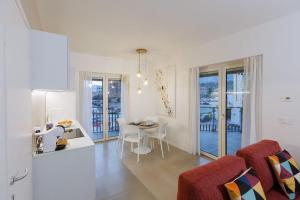 a kitchen and living room with a table and chairs at ZENIT Appartamenti & SPA in Terni