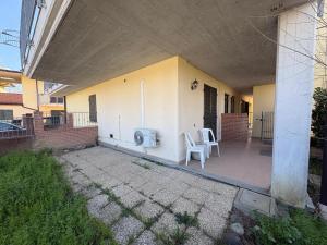 a porch of a house with two white chairs at Ami Affittacamere 2 in Castel San Giovanni +3 photos