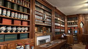 a room filled with lots of wooden shelves at La Perle Bleue - air conditioning - ground floor in Bourg-en-Bresse