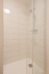 a bathroom with a shower with a glass door at La Perle Bleue - air conditioning - ground floor in Bourg-en-Bresse +13 photos
